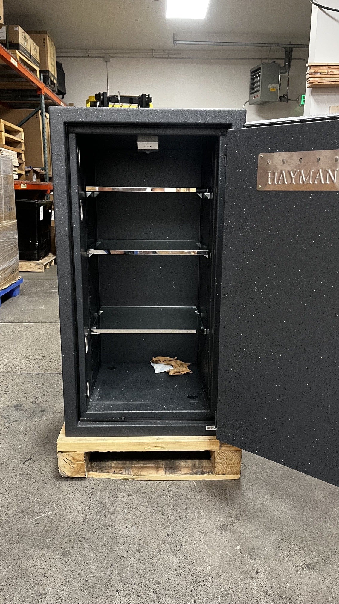 View of the inside of the safe, it has three glass shelves that are adjustable. It also has two predrilled holes to bolt it down to the floor.  