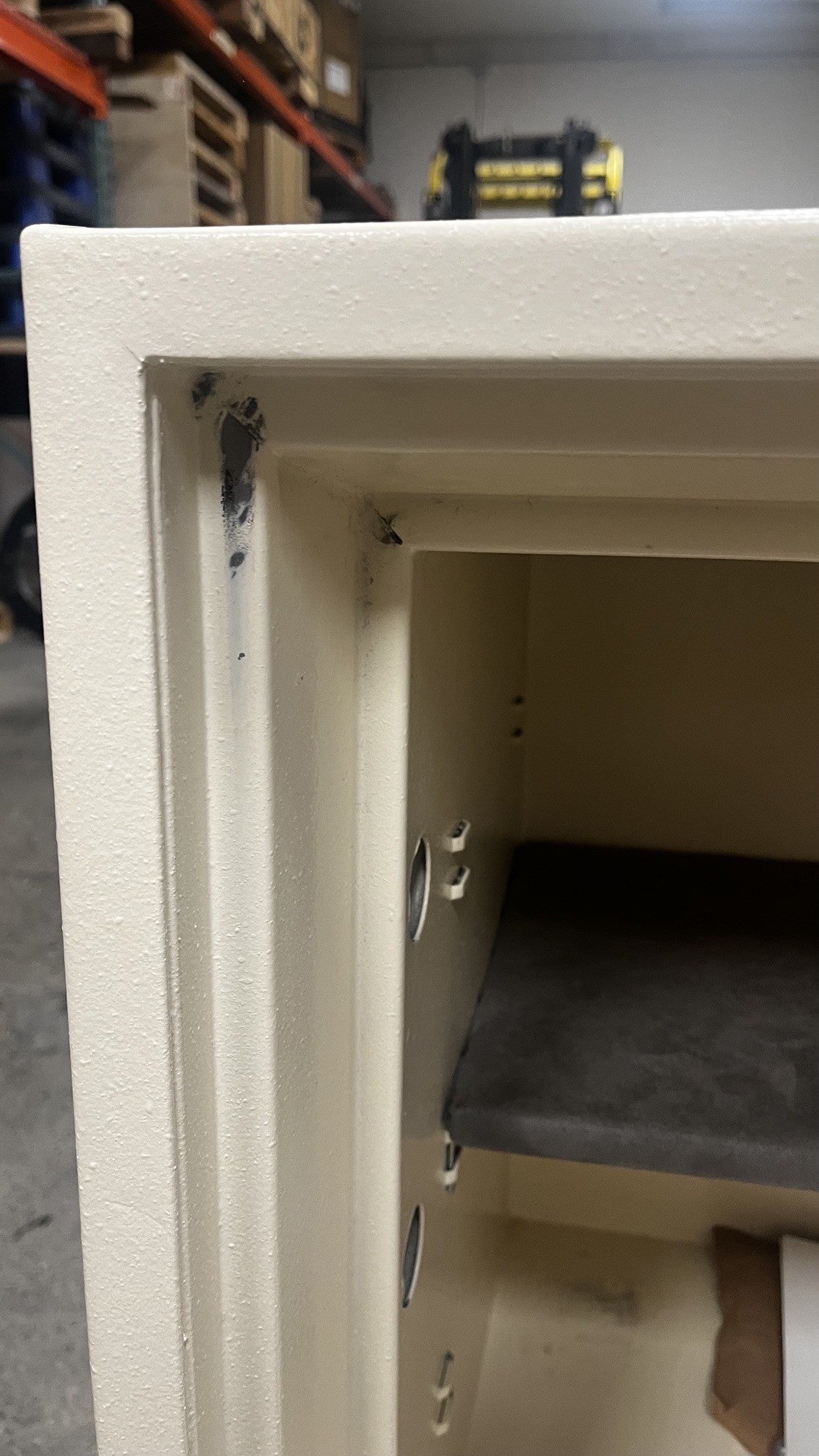 View of scratches on the paint in the upper left corner of the interior of the safe. 