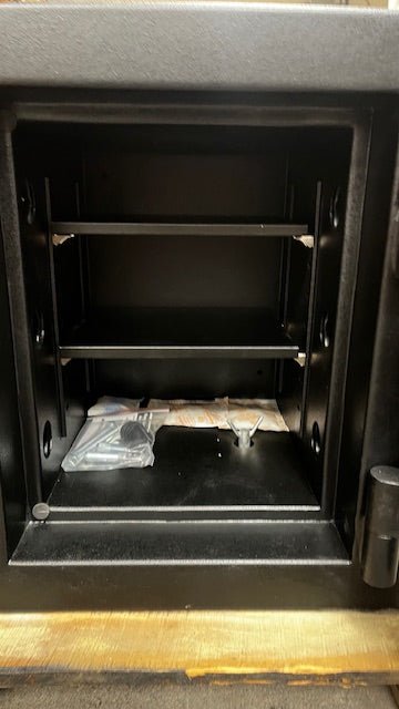 Close-up view of the inside of the safe. It has 2 adjustable shelves, and it comes with the hardware to bolt the safe down. 