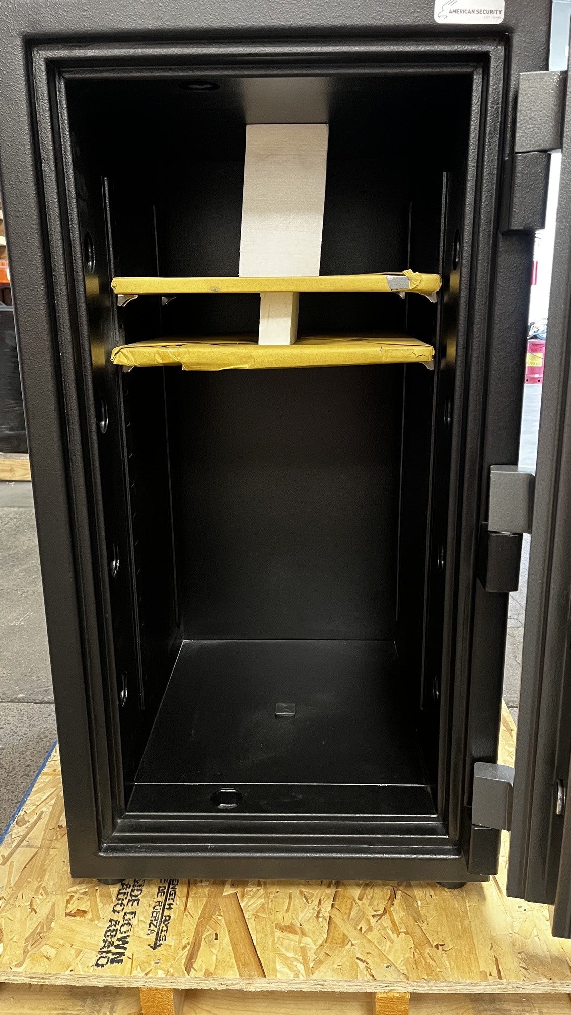 View of the inside of the safe, it comes with two adjustable shelfs and one center bolt down hole. 