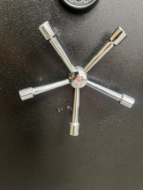 View of the 5 spoke handle, the middle of the handle has scratches. The paint behind the handle has a few small paint chips. 