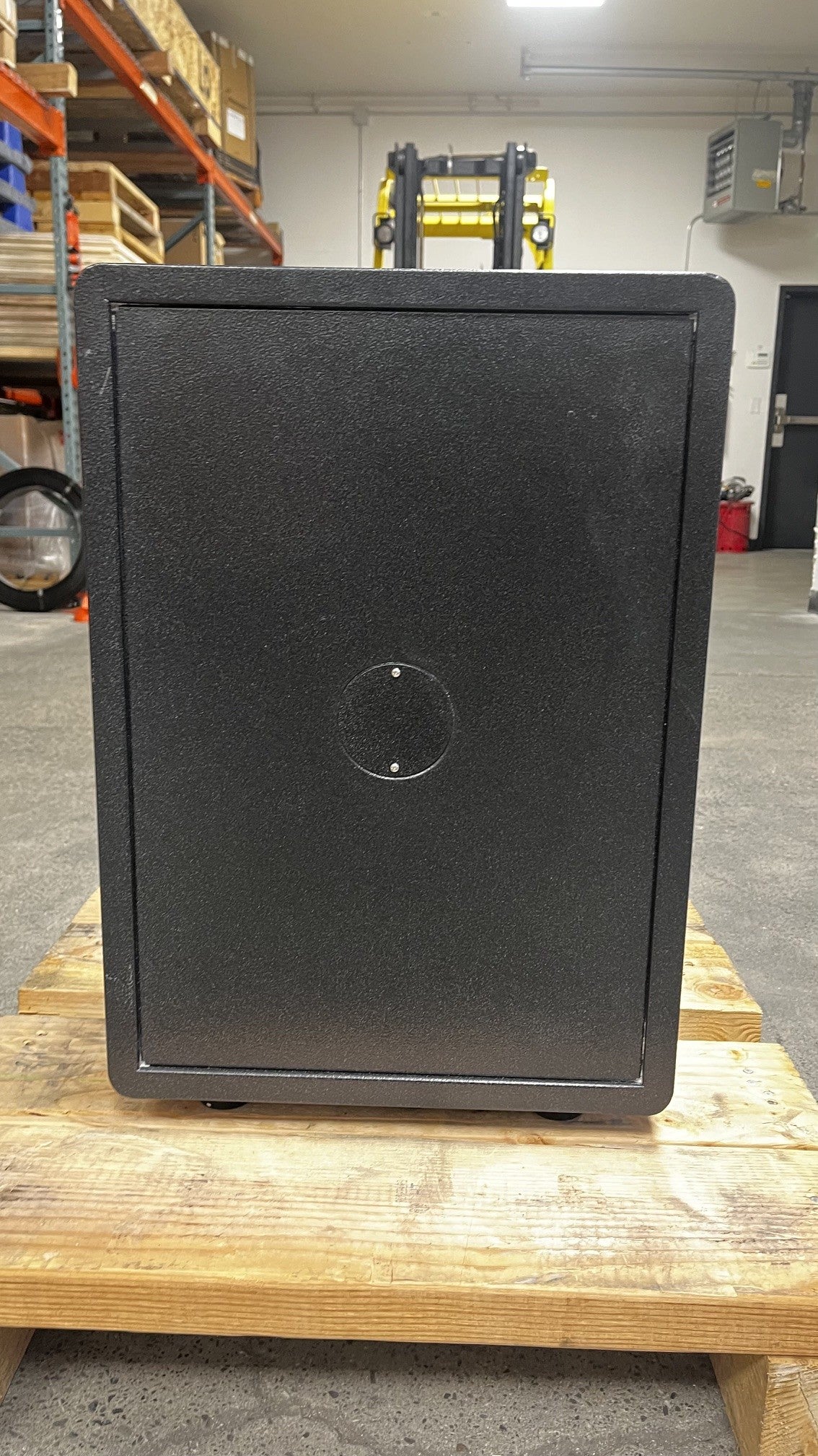 View of the back side of the safe. It has a small scratch on the top left area. 