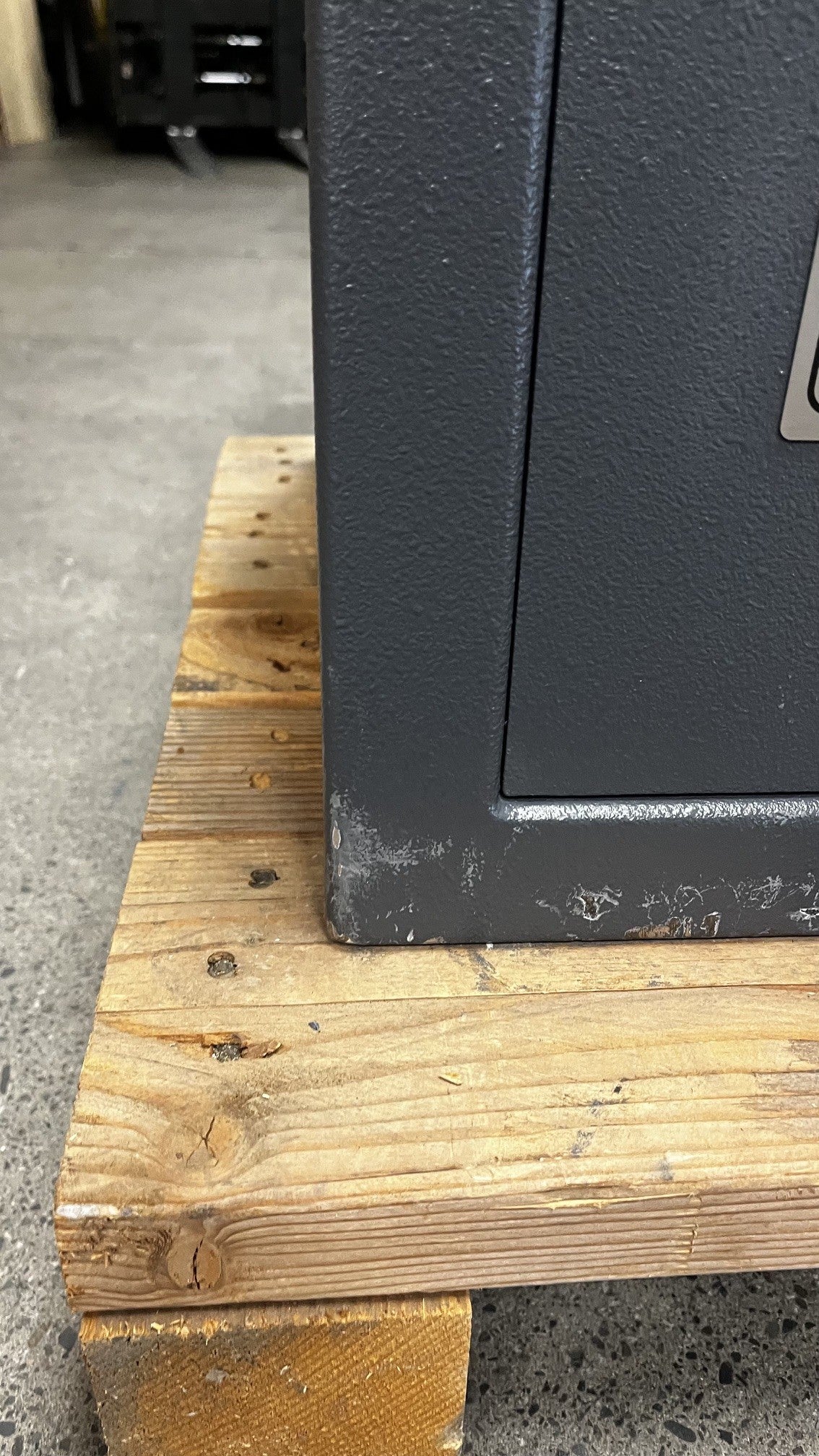 Close-up view of the scratches on the lower left side of the safe.