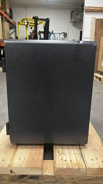 View of the right side of the safe. The top edge has a few dents on the safe. 