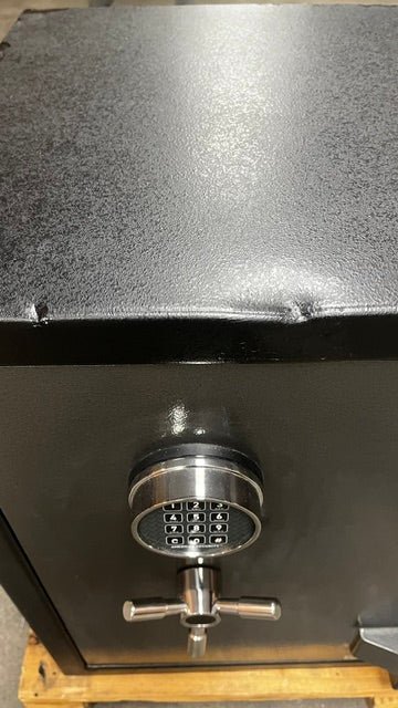 Top view of the safe, the edge has a few dents. The dents have been painted. 