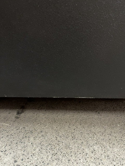View of small paint chips on the bottom edge of the safe. 