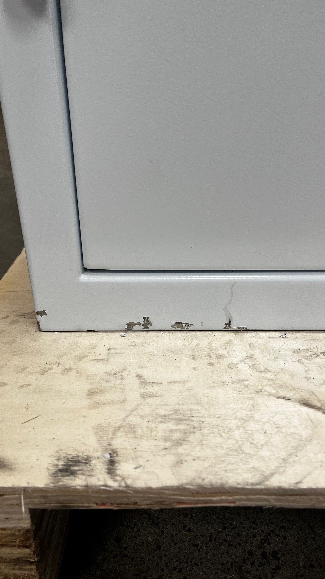 Close-up of few chips on the lower left side of the safe. 