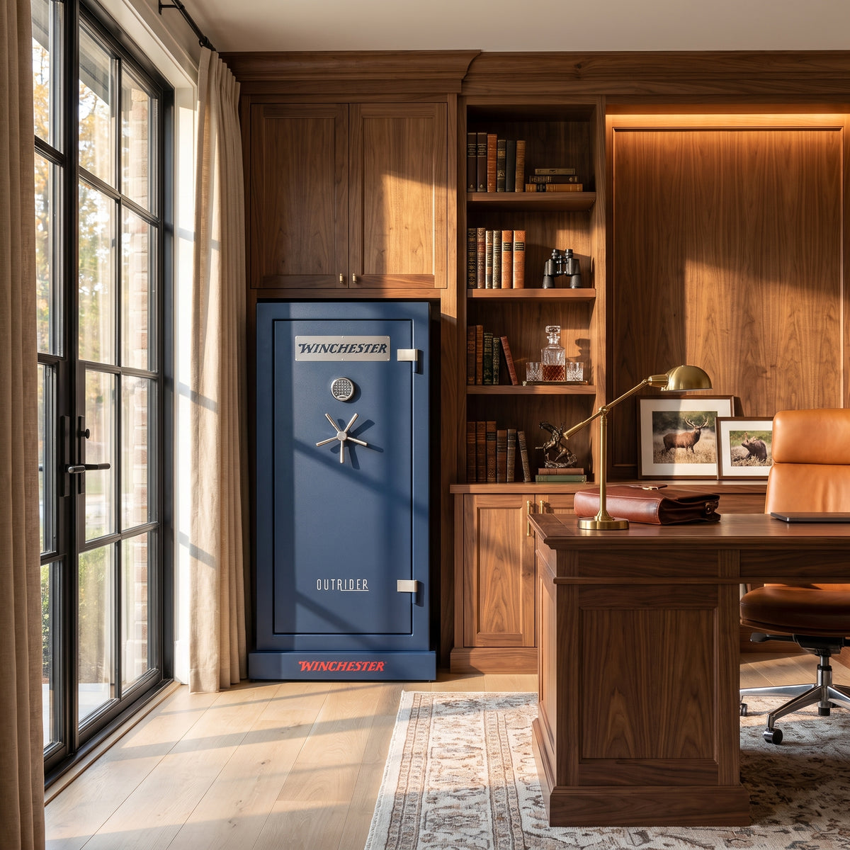 Winchester Outrider 25 Midnight Blue gun safe placed in a wood-paneled home office next to a leather chair and bookshelves
