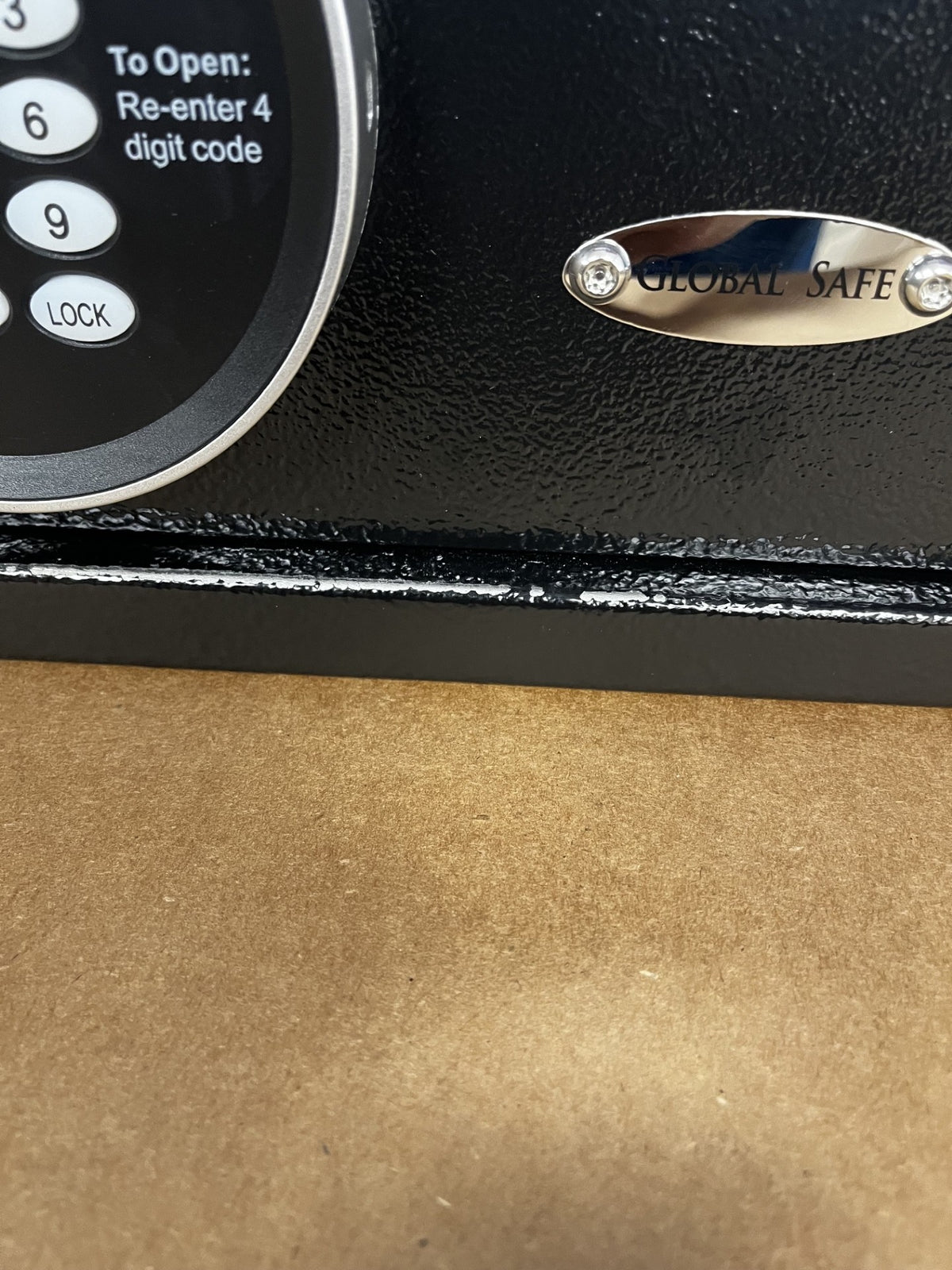 The front of the safe has paint chips alongside the bottom edge where the door seats. 