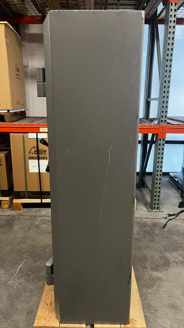 View of the right side of the safe, the body has multiple scratches and chips on the paint. 