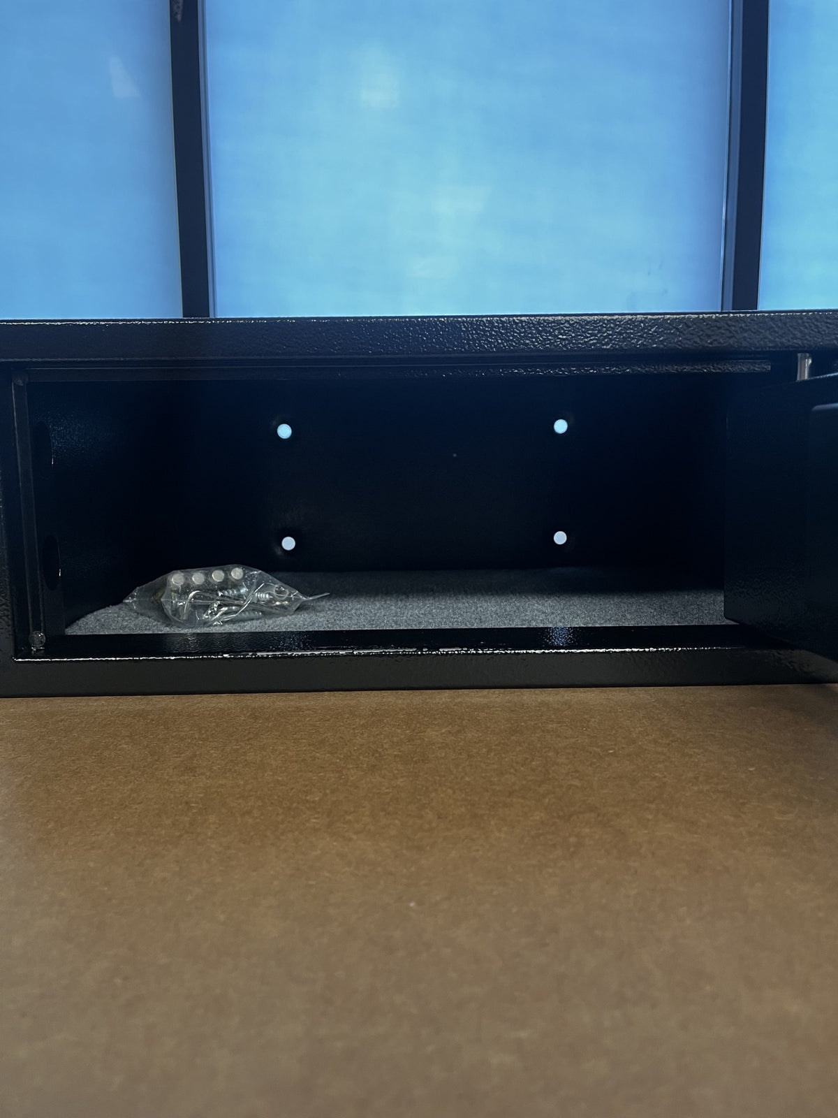 View of the inside of the safe. It comes with the hardware, backup keys, and batteries for the safe. 