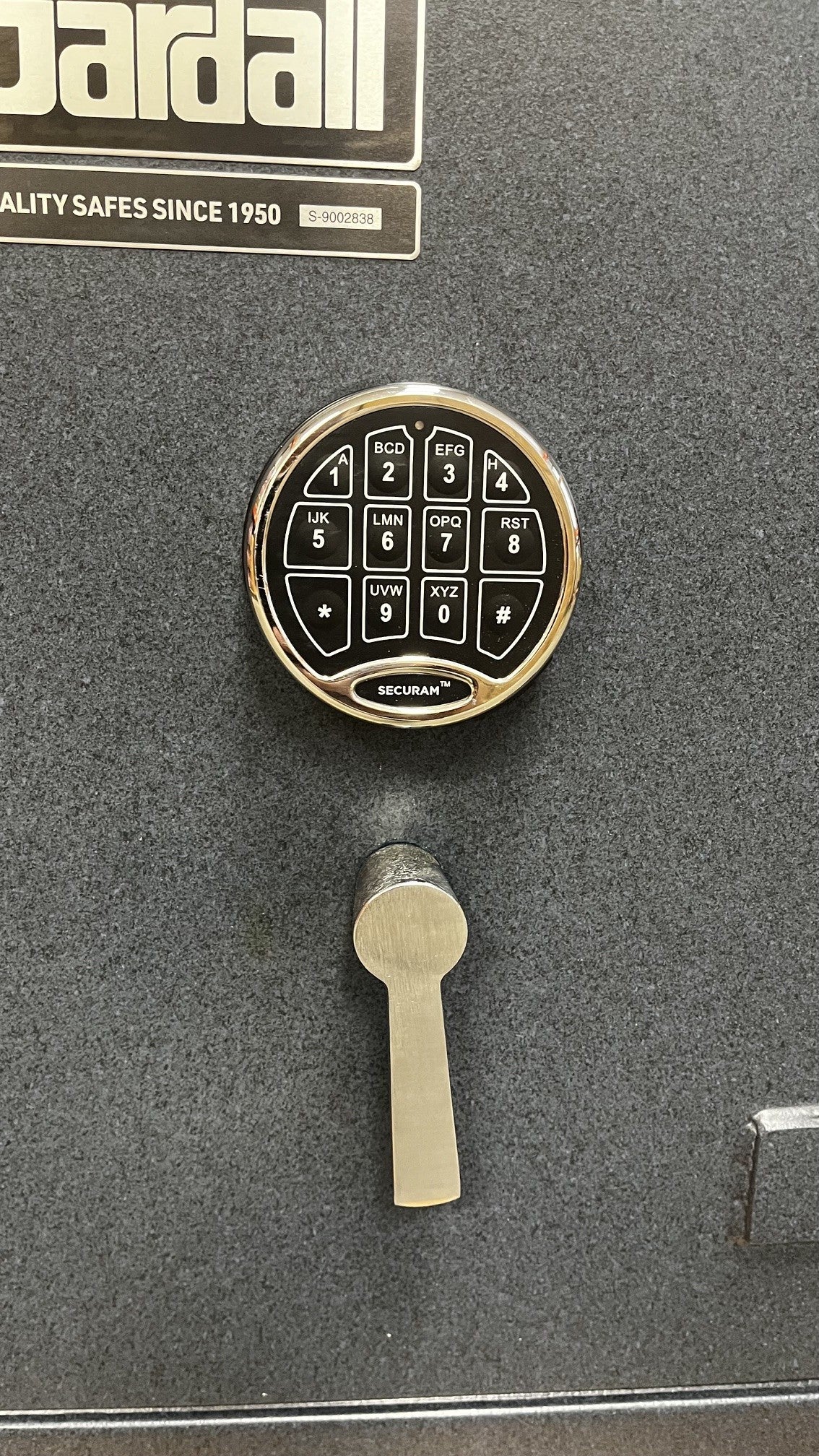 Close-up view of the Securam digital lock and the handle. 