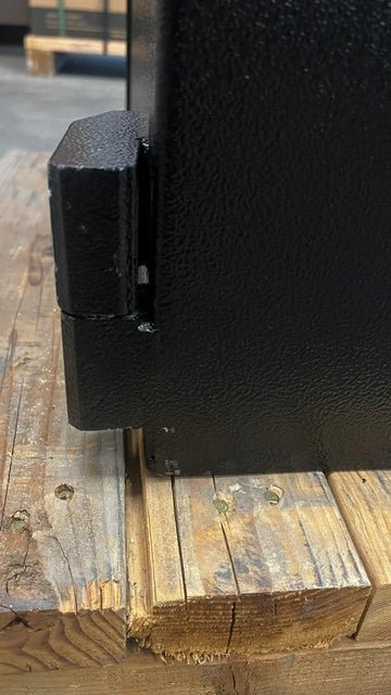 The lower left corner from the right side of the safe has a small chip on the paint. 