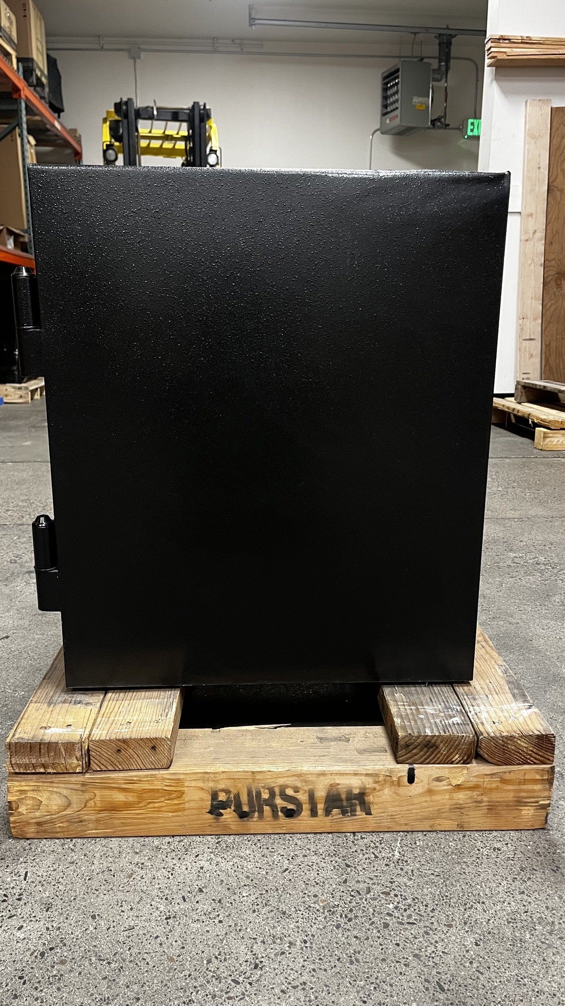 Right side view of the safe. The top right corner has a dent. 
