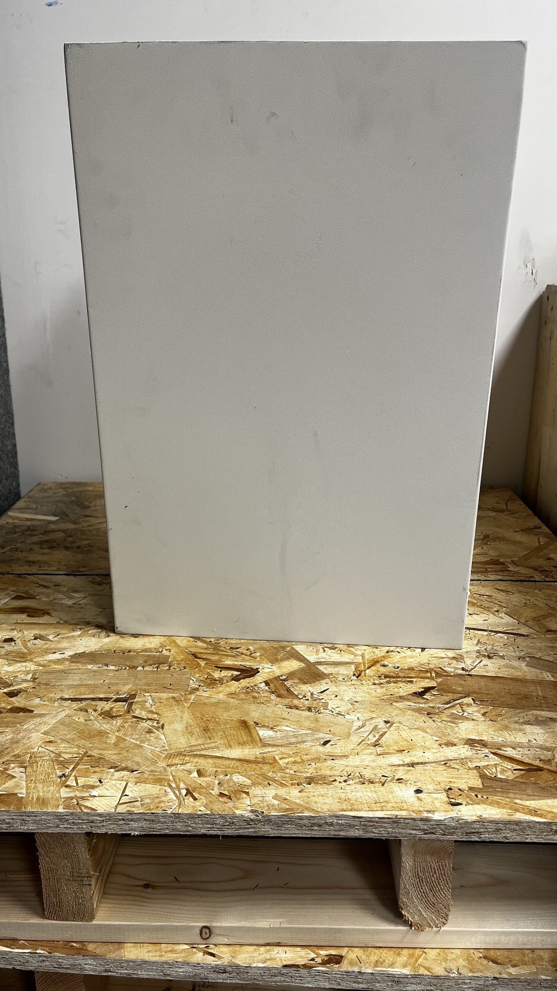 View of the back of the safe. The top right corner has a small dent. 