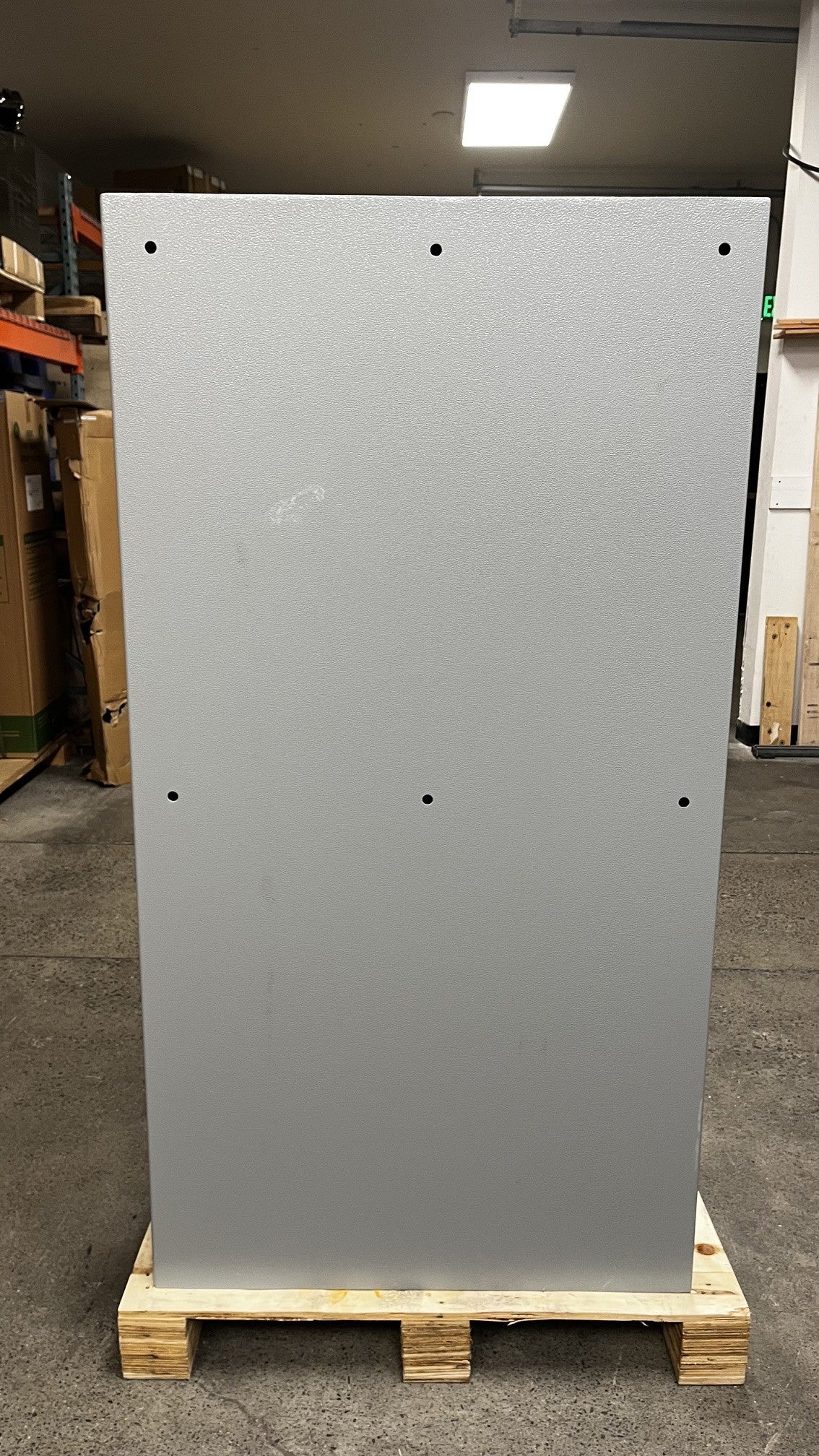 Back side view of the safe. The back has six predrilled holes in the back to mount it to a wall. It does have a scratch on the back as well. 