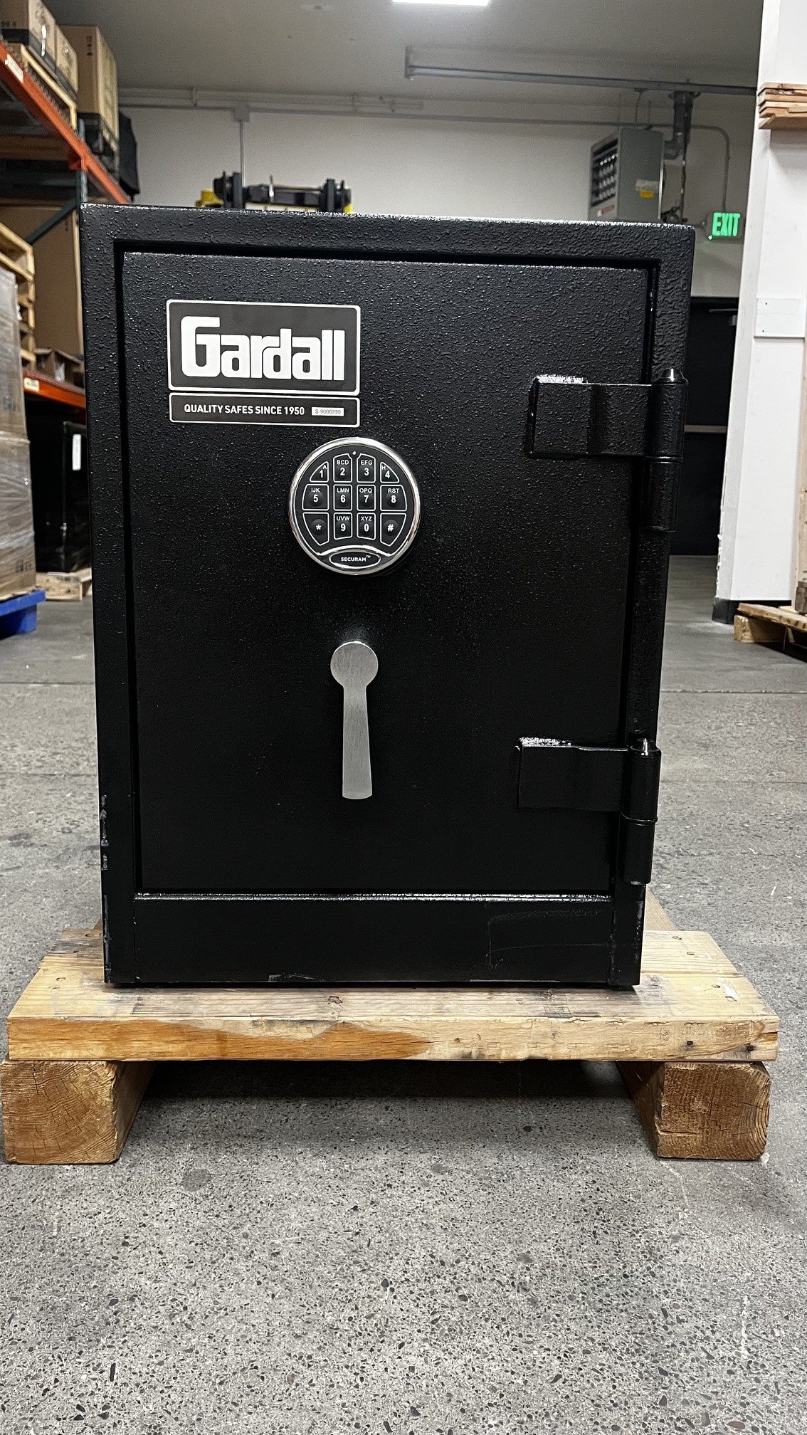 Front view of the safe, it has a few scratches alongside the left edge of the safe. The safe also, has scratches on the lower right side of the safe. 