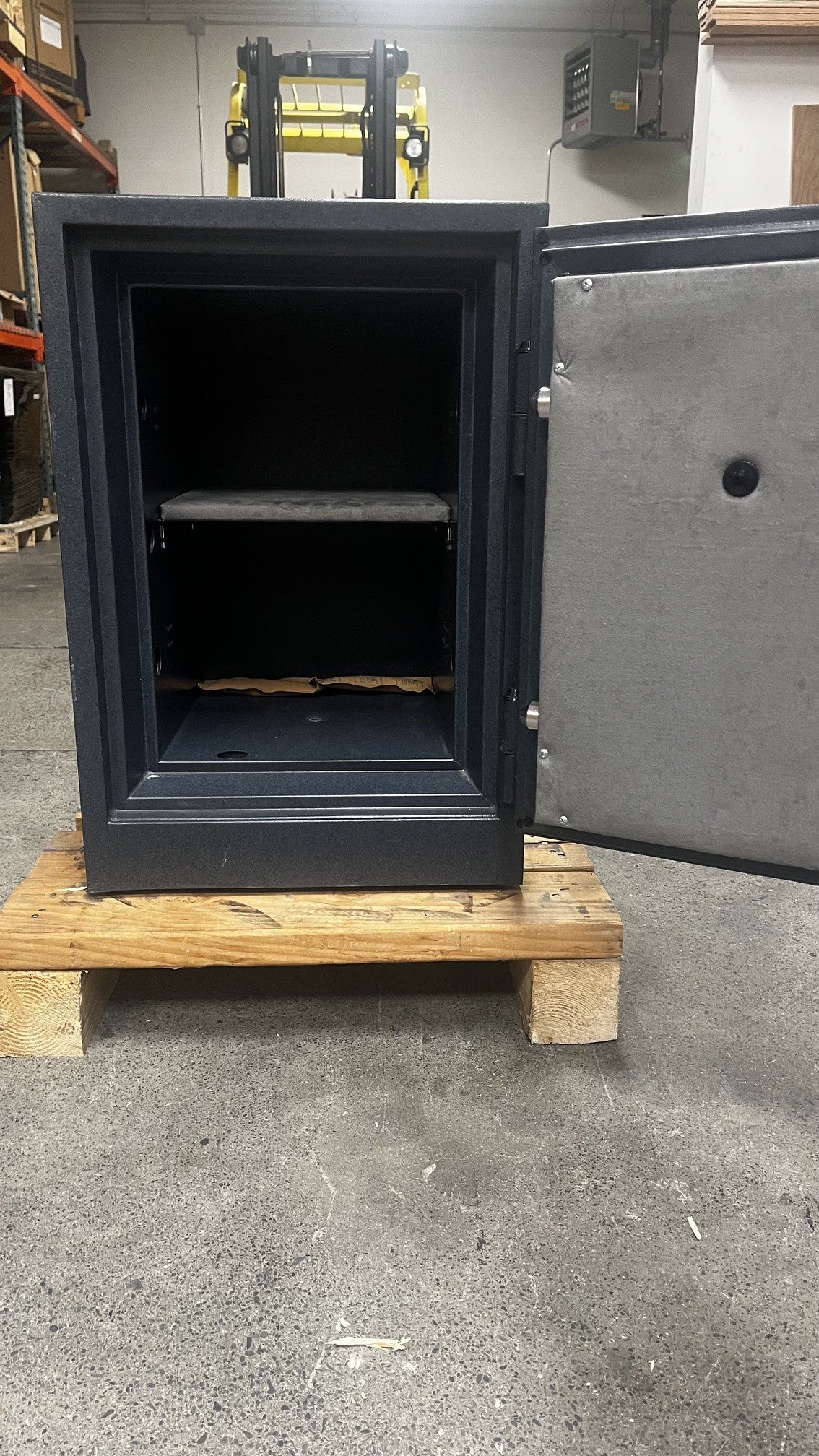 View of the safe with the front door open. It comes with one adjustable shelf. 