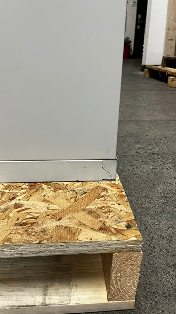 View of small scratch on the lower area of the file cabinet. 