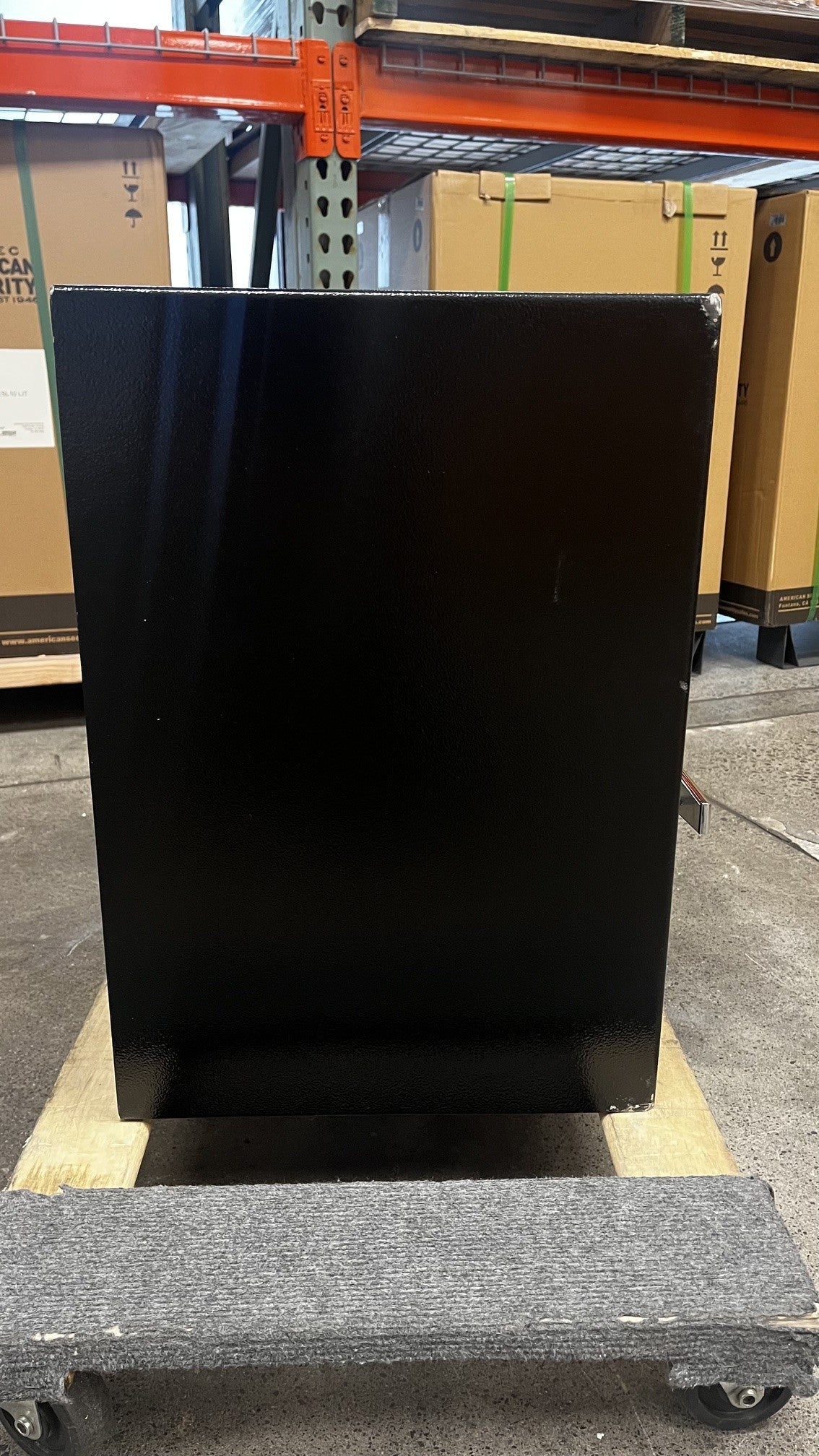 View of the left side of the safe. The chips on the corners are visible. The top right and lower right area of the safe is where the chips are located. 