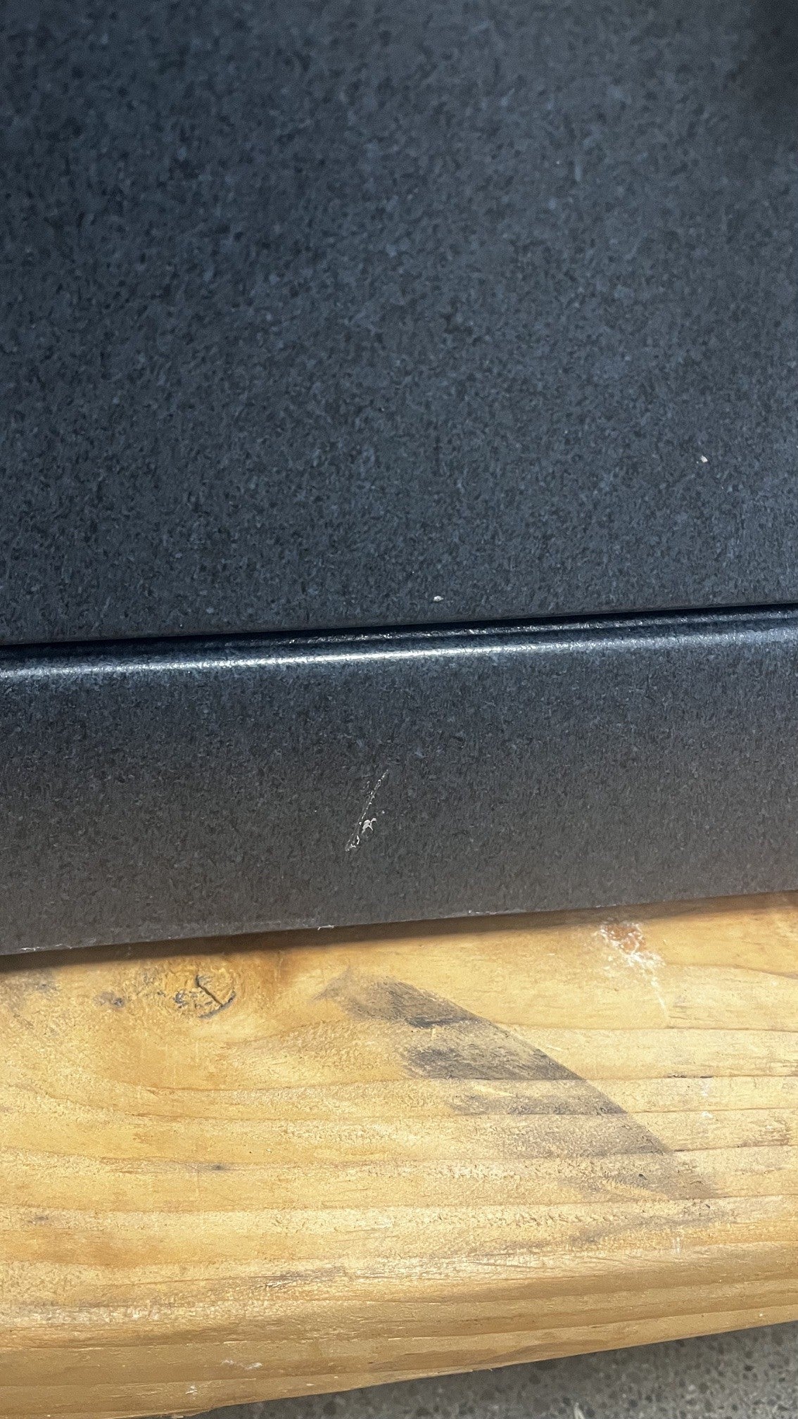 View of a small paint chip on the lower front area of the safe. 