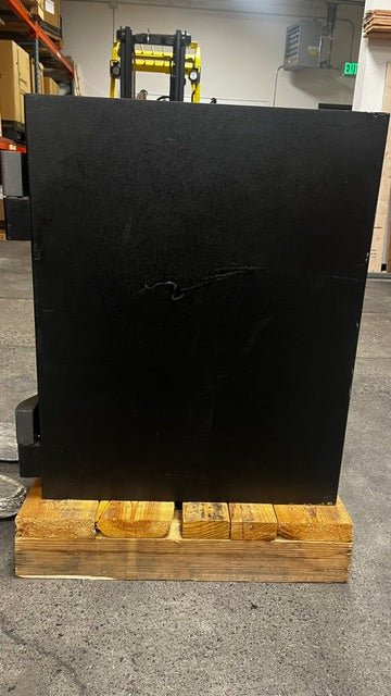 View of the right side of the safe. There is a scratch on the middle of the safe. 