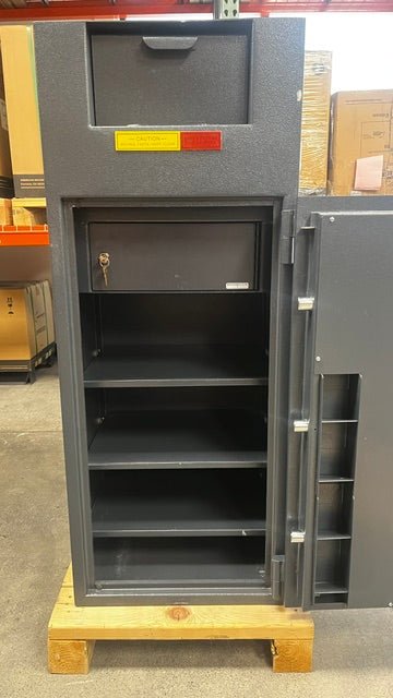 View of the safe with the door open, it has an interlocker where the deposit go into. The interlock is only able to be accessed with a key which is provide with the unit. It also comes with three adjustable shelves. The door has four slots to place rolls of coins on. 