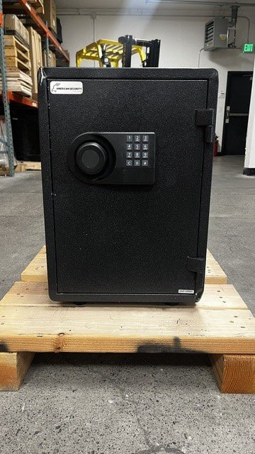 View of the front of the safe. The front top left corner has a big dent on it. The lower right corner also has a dent. 