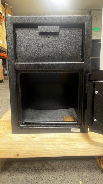 View of the safe with the door open, the safe has four predrilled holes to be bolted down. 