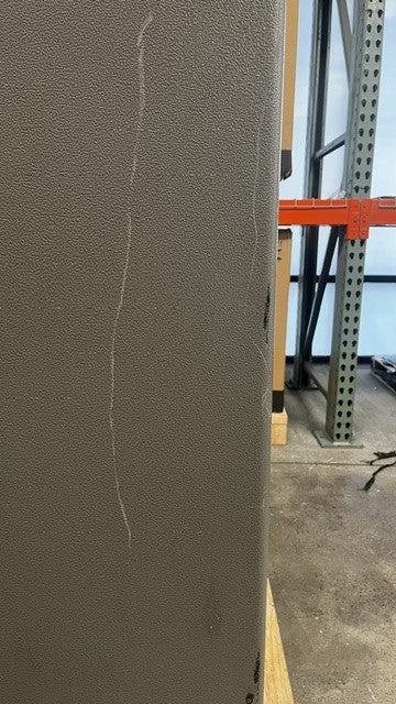 View of scratches alongside the back edge of the safe. 