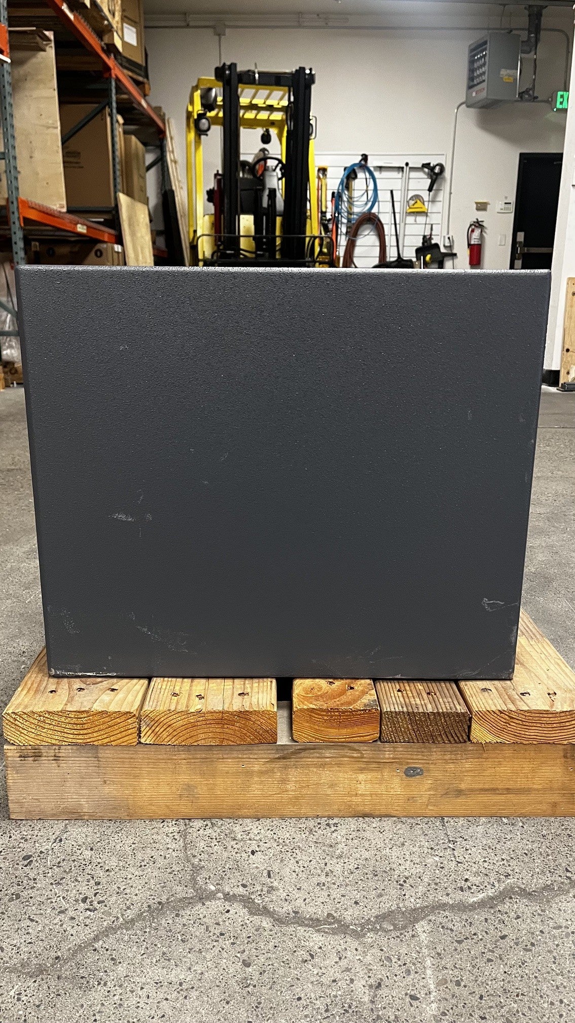 Left side view of the safe, the safe has a few scratches on the body and lower area of the safe. 
