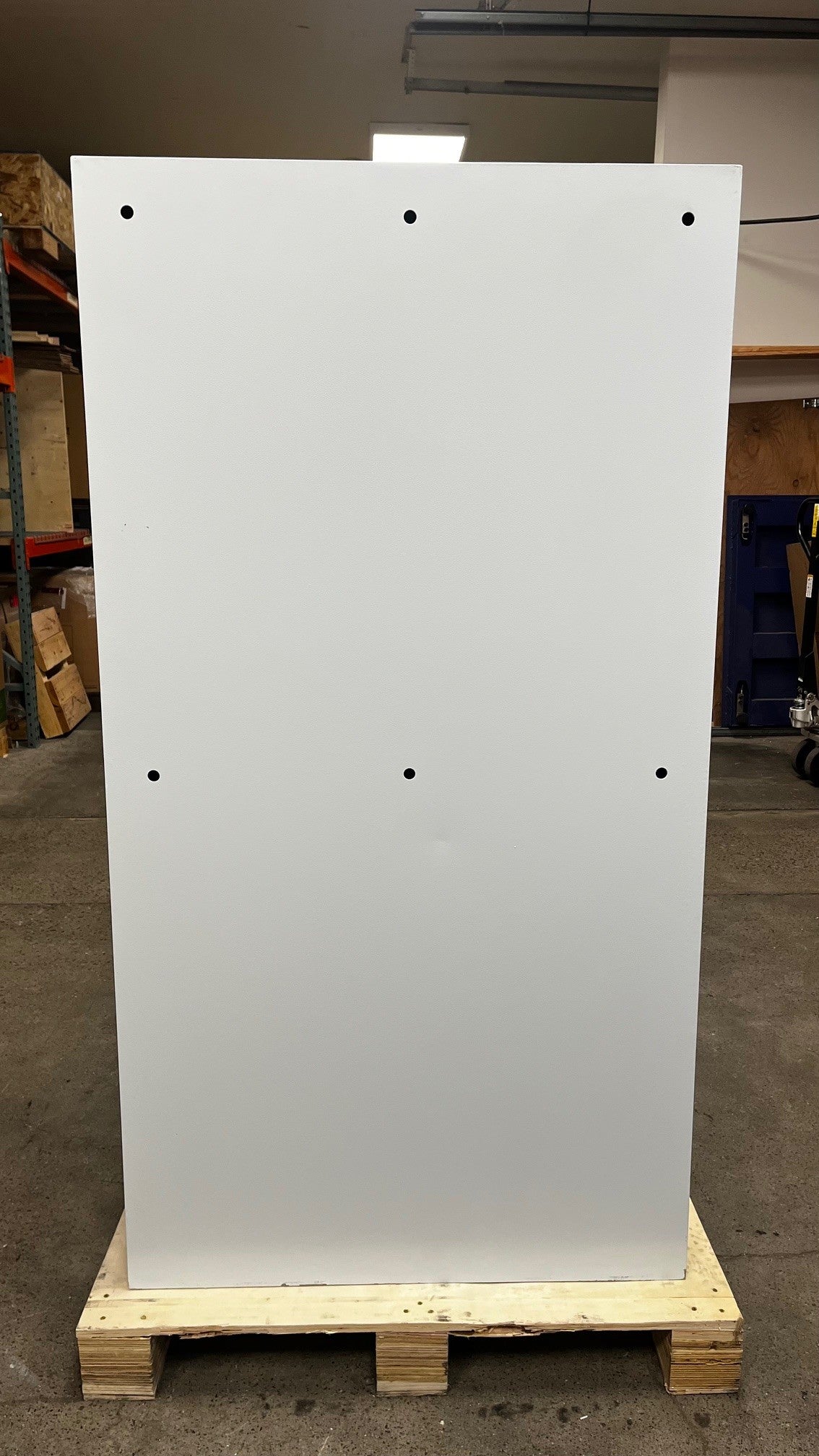 View of the back of the safe. It has 6 predrilled holes to mount onto a wall. 