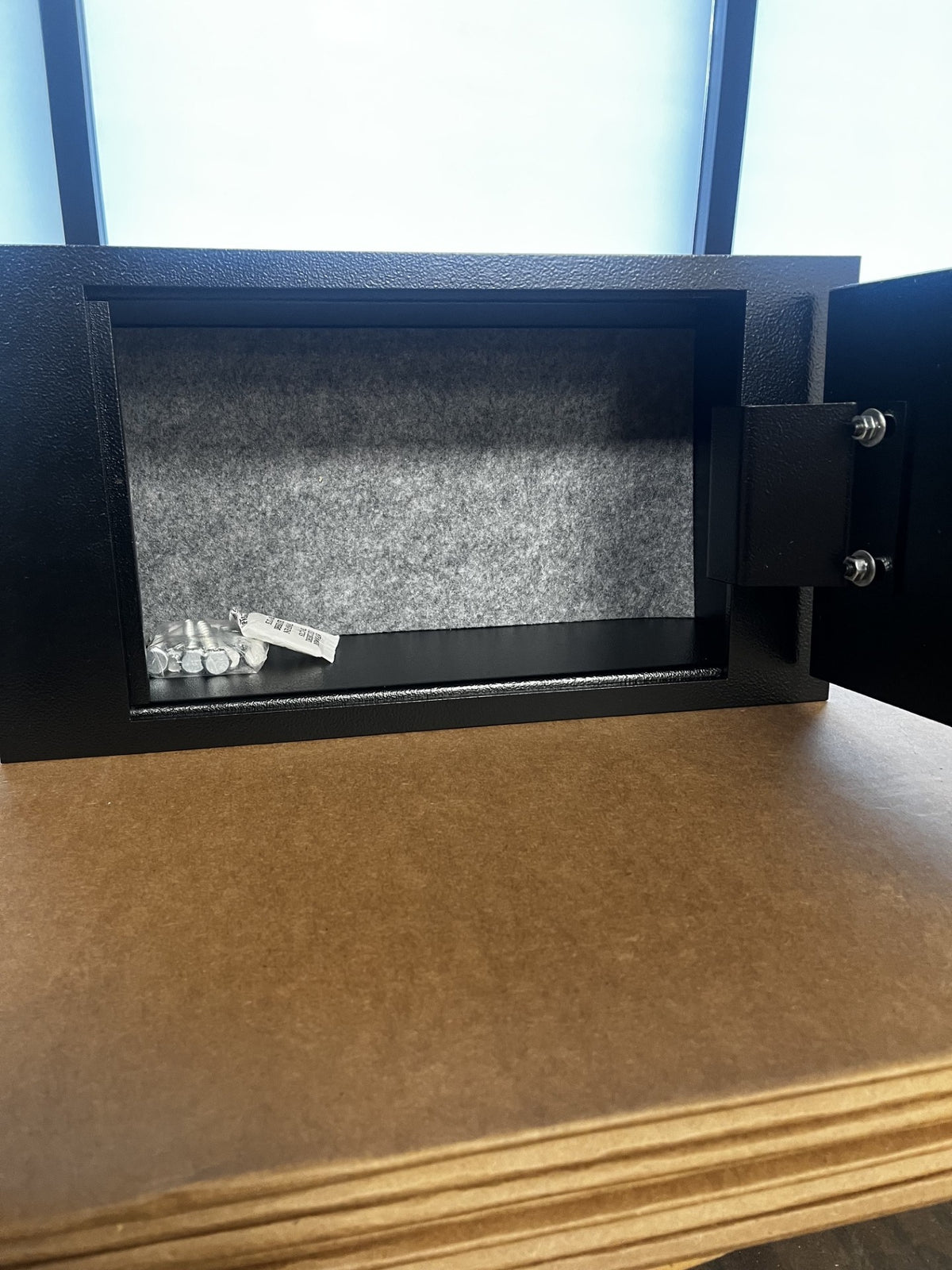 View of the safe open, it includes the mounting hardware. 