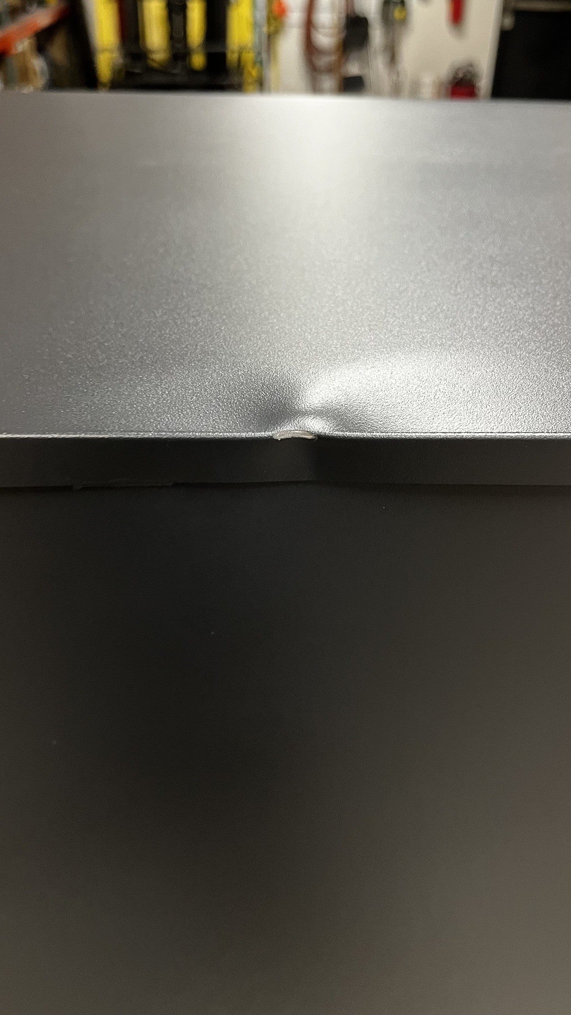 The top edge has a dent on the back of the safe. 