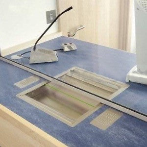 Overhead view of a blue-grey counter with two STS-K003 flush-mount speaker cutouts and the staff gooseneck microphone