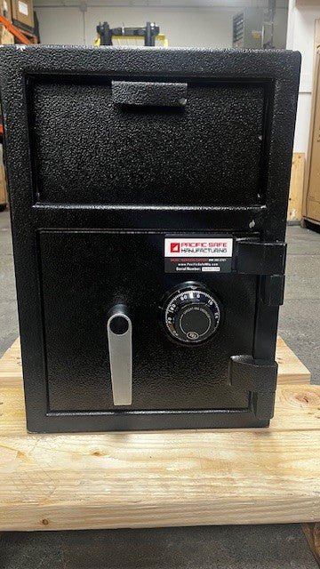 Front view of the safe, the front has a few chips on the paint. One on the top left edge. Another one on the handle for the drop-down door and one more near the top hinge. 