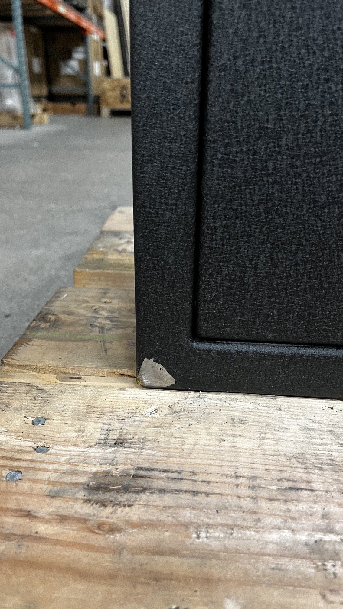 Close-up of the bottom front corner where the paint is chipped.