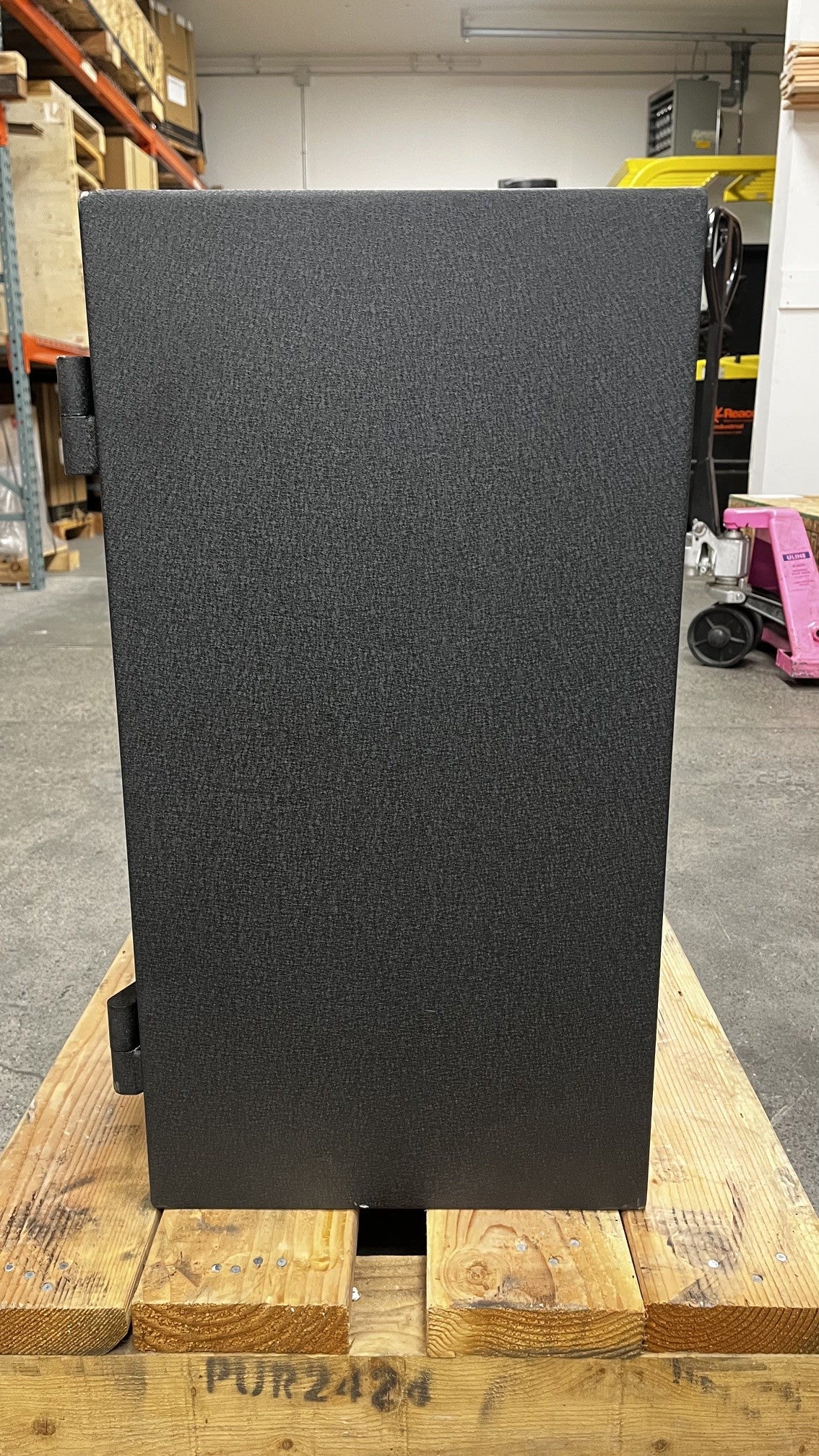 View of the right side of the safe. The bottom edge has a small chip on the paint. 