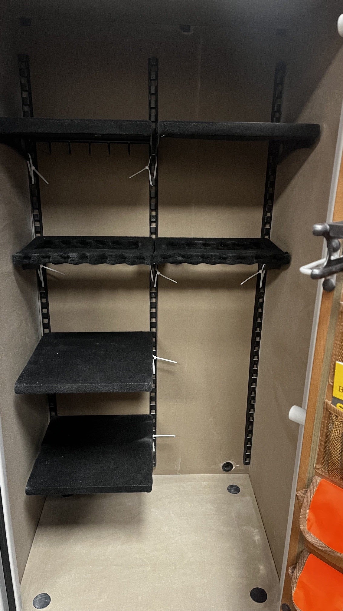 Inside view of the safe, it comes with six adjustable shelves. It also has a hole on lower back area of the safe to pass a power cable into the safe. 