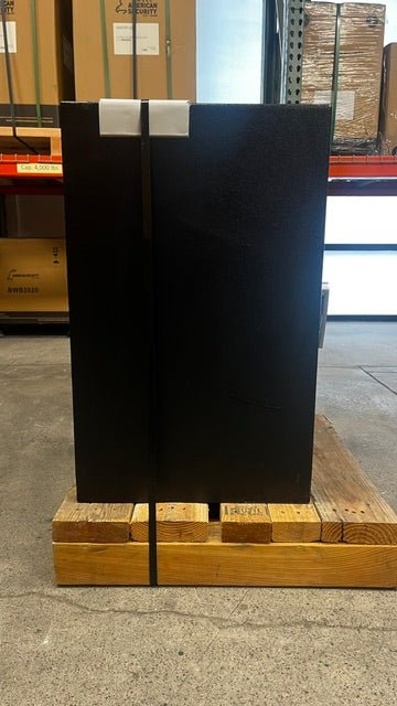 Left side view of the safe, the safe has been strap down to the pallet to keep it from falling forward. 