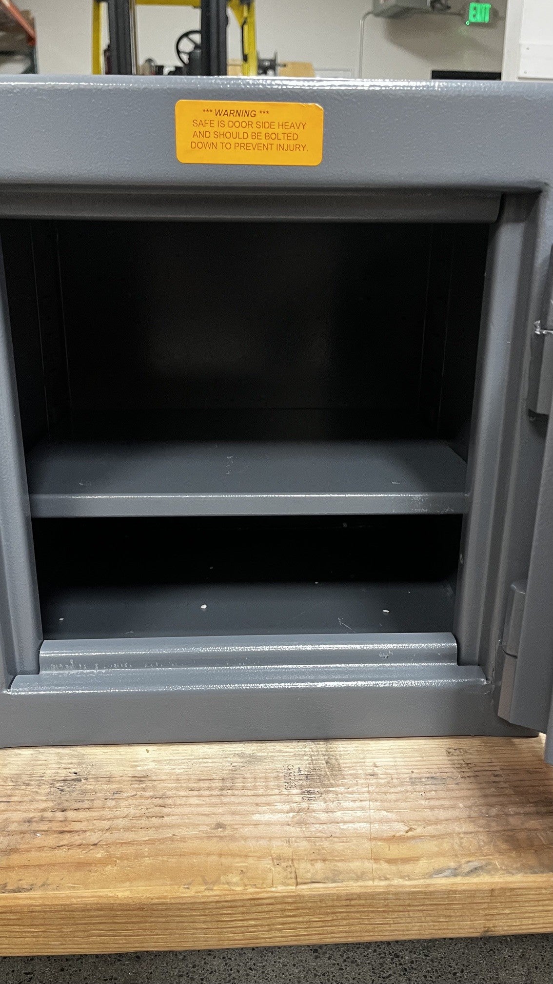Close-up view of the inside of the safe. The shelf has small scratches on it. The shelf is also adjustable. 