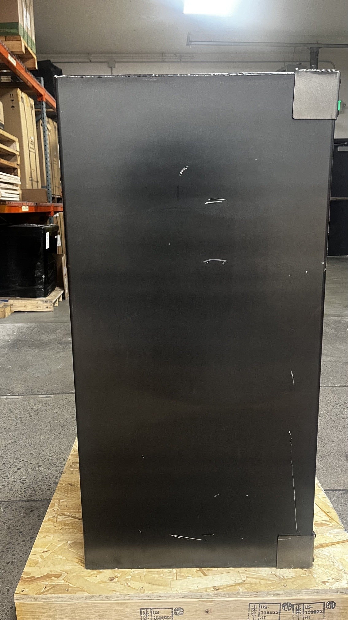 View of the left side of the safe. It has a few scratches throughout the body. 