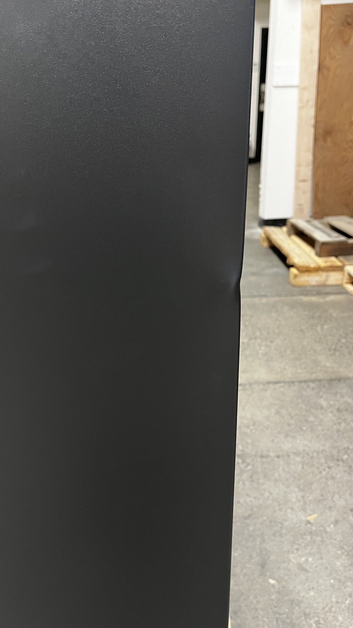 View of a dent alongside the edge of the safe. 