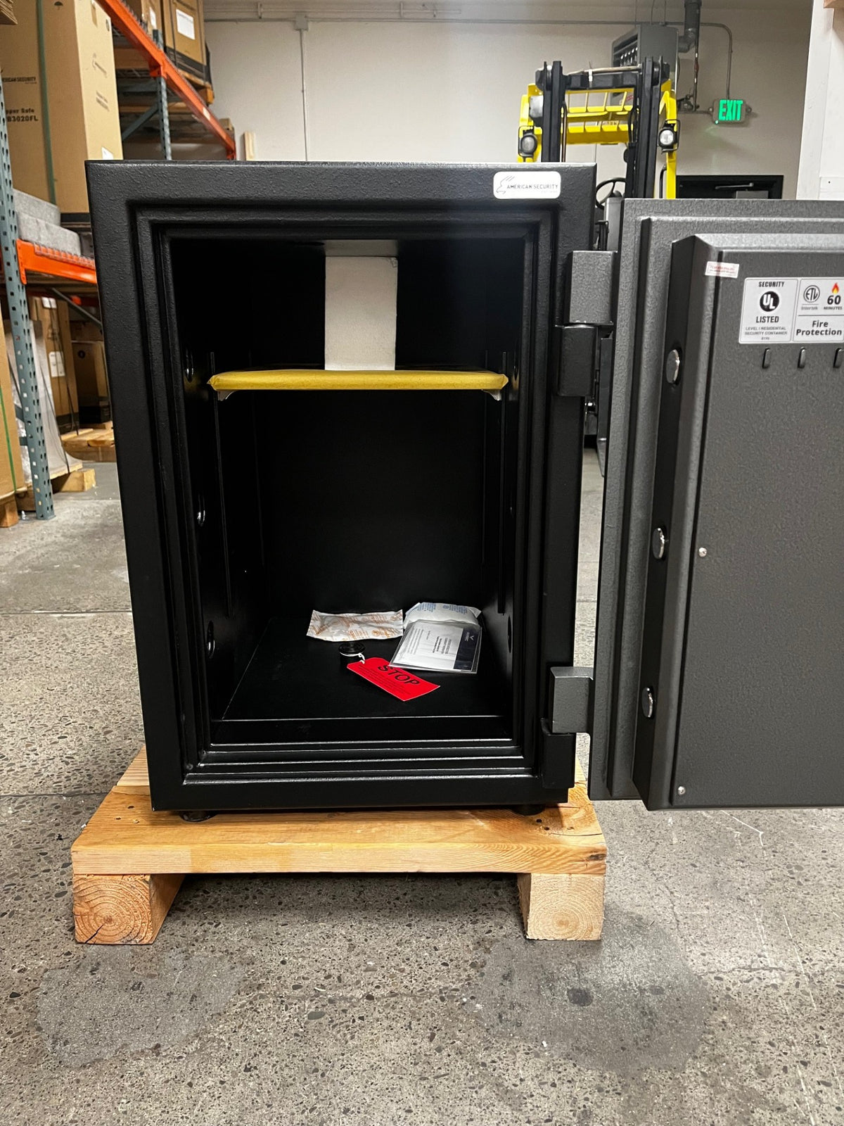 View of the safe with the door open at 180 degrees. The inside has one shelf that is adjustable. The safe also has one blot down hole in the middle. 