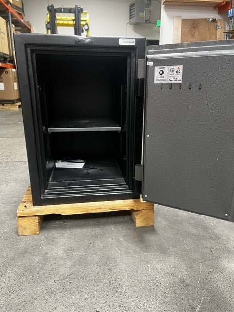View of the safe with the door open, it comes with one adjustable shelf. It also has a center bolt down hole. 
