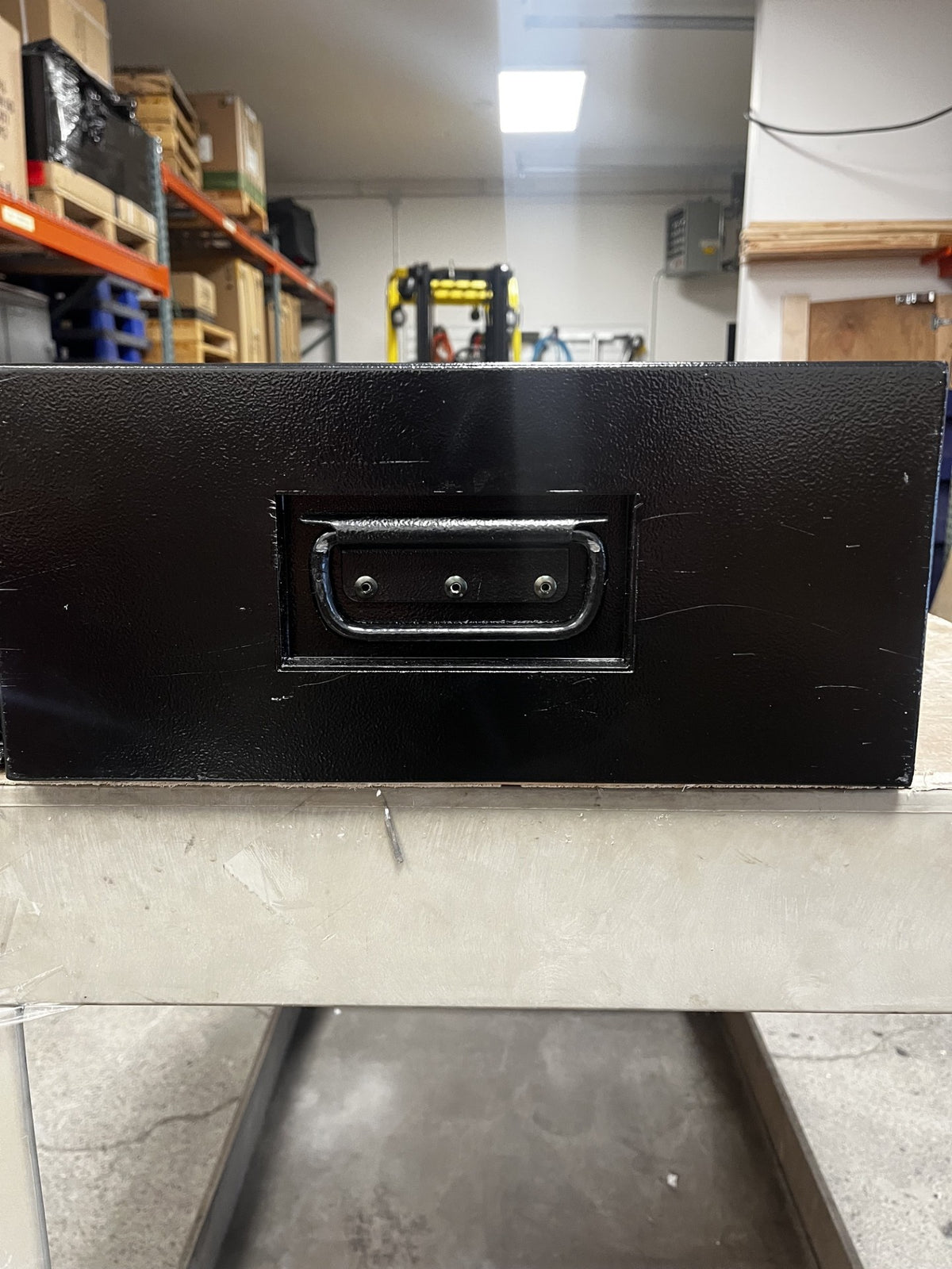 View of the left side of the safe. It has a few scratches on the body. 