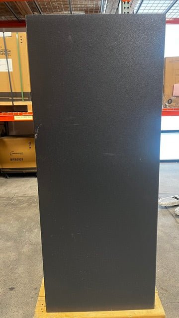 View of the back side of the safe. It has a few scratches throughout the back area.