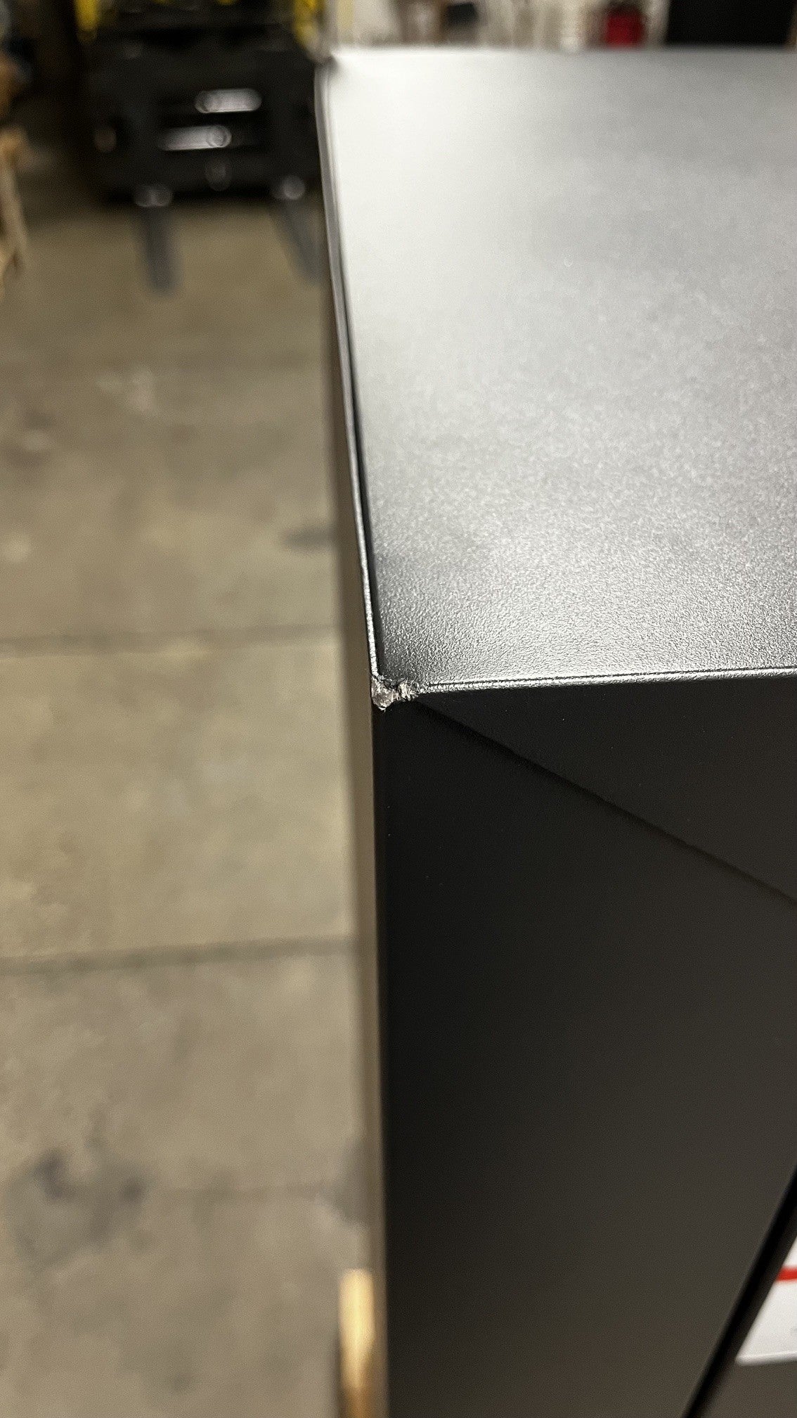 View of a chip on the top left corner of the safe. 