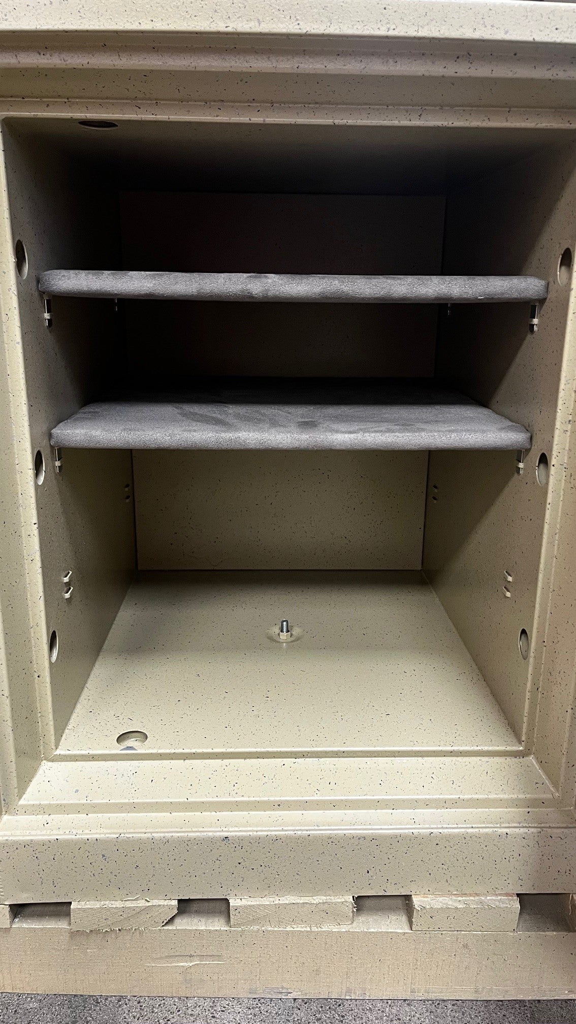 Inside view of the safe, it comes with two adjustable shelves and a center bolt down hole. 