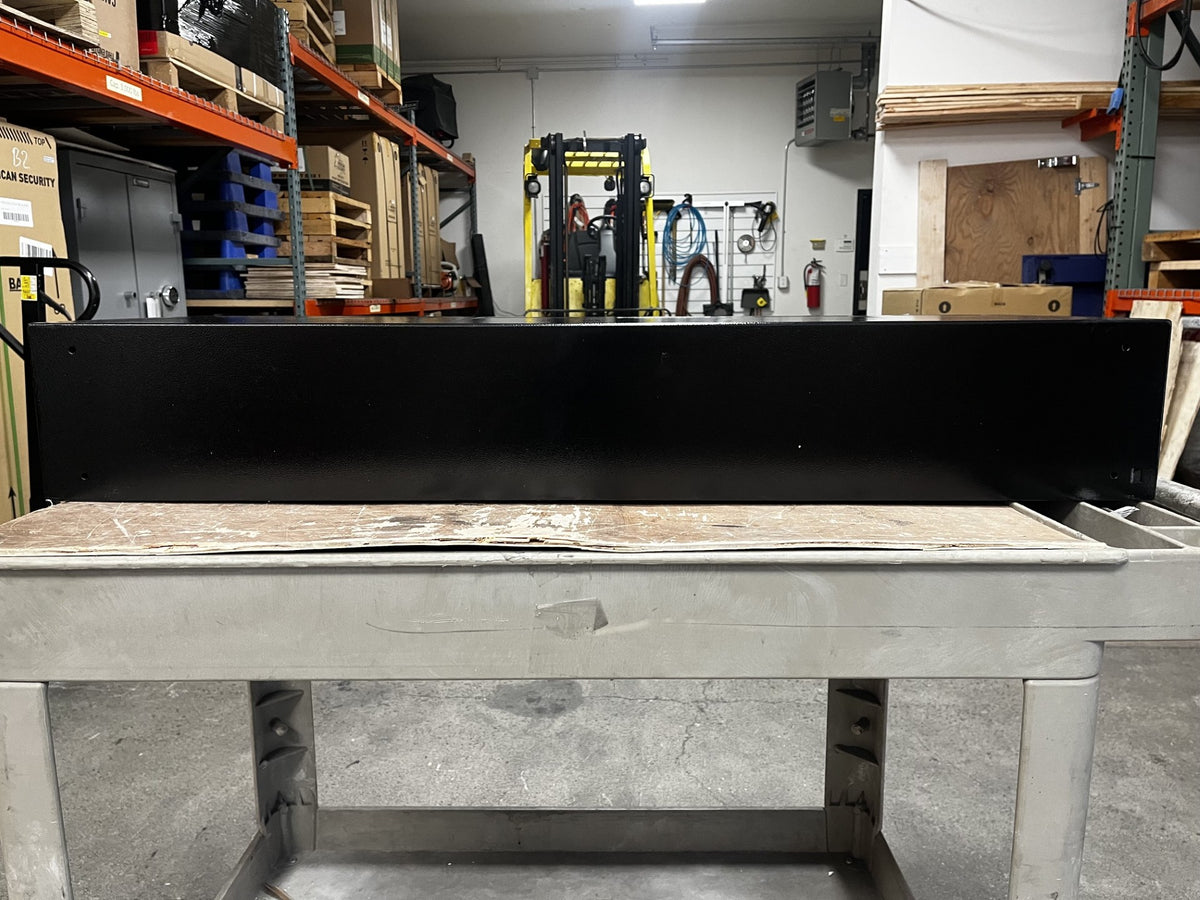View of the back of the safe. It has four predrilled holes on the back to mount the safe to a wall. 